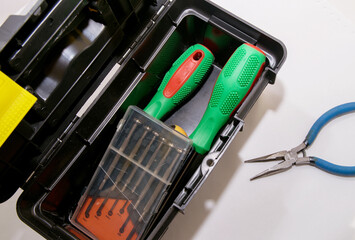 Screwdrivers are in a gray open tool box