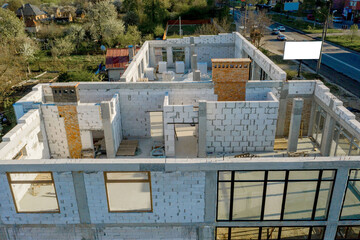 Building site of a house under construction made from white foam concrete blocks. Building new frame of home