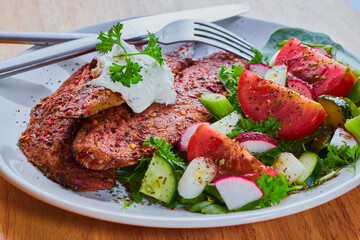 Grilled mackerel fillets with mixed salad and mayonnaise.