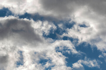 Detail of towering dramatic clouds in the Andean skies, stormy cloud formations laden with water about to precipitate, contrasted by the afternoon lights.