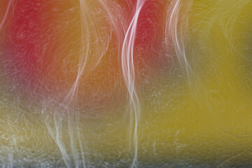Detail of curious abstract shapes that form in soap bubbles, illuminated with natural light and...
