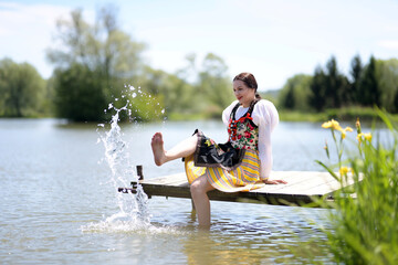 Young beautiful slovak woman in traditional costume on summer 