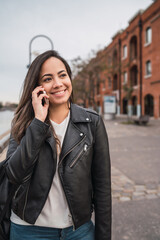Latin woman talking on the phone.