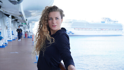 Girl circus gymnast performs a show on the air hoop. flexible acrobat spins on a ring in the air on a black background. slender young girl performs split in the air