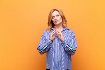 middle age woman feeling proud, mischievous and arrogant while scheming an evil plan or thinking of...
