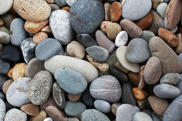 Stones by the sea, pebbles on the beach, sea coast.