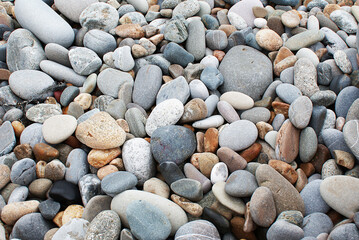 Stones by the sea, pebbles on the beach, sea coast.