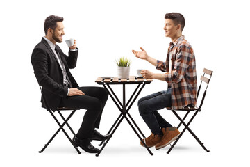 Male student sitting at a wooden table and talking with a businessman - Powered by Adobe