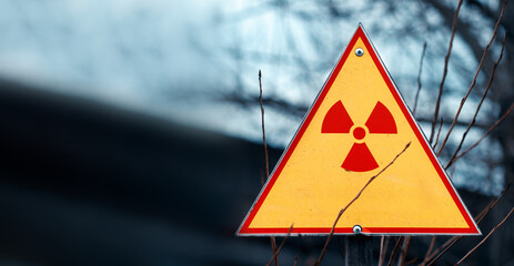 Sign of radiation hazard against radioactive waste, picture with a blured place for your text, copy...