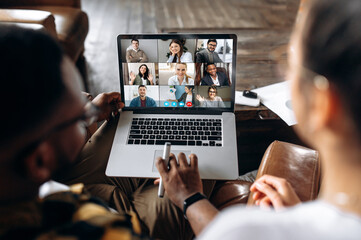 Online business meeting. Business colleagues communicate by a video conference using a laptop,...