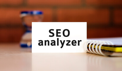 Seo analyzer text n white sheet with notepad and hourglass