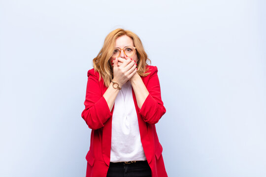 middle age woman covering mouth with hands with a shocked, surprised expression, keeping a secret or saying oops