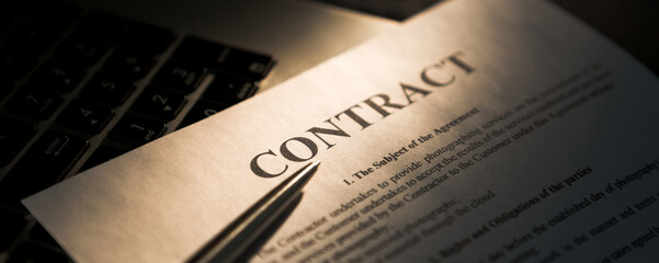 Pen for signing the contract. The pen and contract are on the laptop.