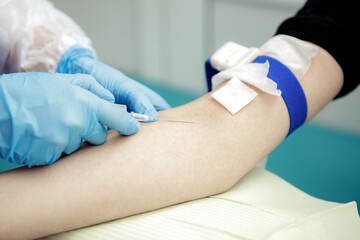 The doctor or nurse takes blood on the analysis from a vein.