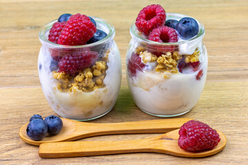 yogurt glass with muesli, blueberries and raspberries