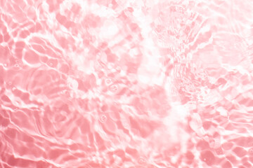 Obraz premium Soft focus lite pink cosmetic moisturizer floral water, micellar toner, or emulsion abstract background. Reflections of scattered sun texture.