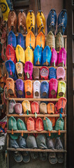 Fototapeta na wymiar Colorful handmade leather slippers babouches on a market souk in the medina of Marrakech, Morocco