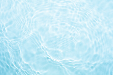 Soft focus lite blue gray cosmetic moisturizer floral water, micellar toner, or emulsion abstract background. Reflections of  scattered sun texture.