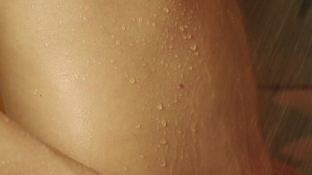 woman taking a shower in slow motion. a beautiful girl is washing and having fun in the shower, close-ups of her hands, back and chest drops drip over the skin. Close-up.
