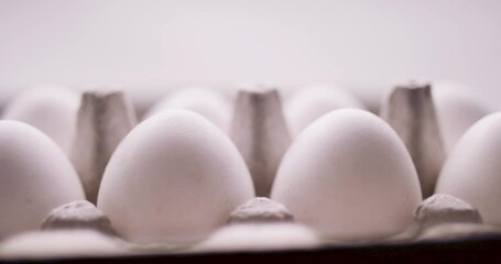 Carton of a dozen eggs. National egg day. Shot in slow-motion in 4k. Carton of farm fresh eggs.