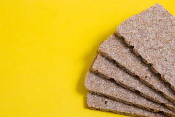 rye bread crisps on a yellow background place copy, proper and healthy nutrition concept, diet foods for breakfast