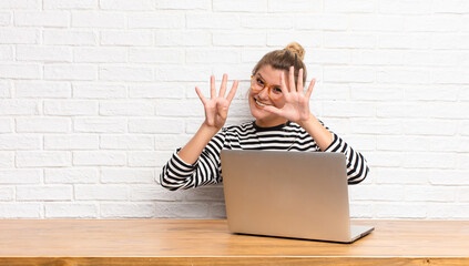  smiling and looking friendly, showing number nine or ninth with hand forward, counting down