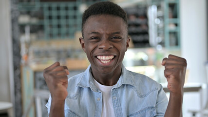 Portrait of Excited Young African Man Celebrating Success