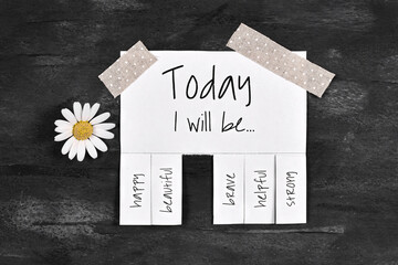 White tear-off stub note with text 'Today I will be...' and words 'happy, beautiful, brave,...