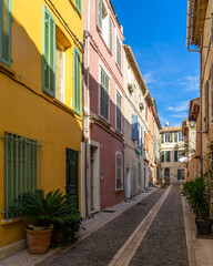 A pedestrian alleyway with colorful houses in the picturesque resort town of Cassis in  Southern France