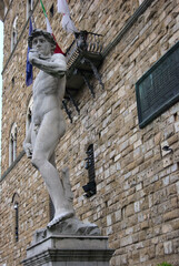 The David, sculpture made by Michelangelo Buonarrotti located in Piazza della Signoria in Florence, Italy. Palazzo vecchio in the background