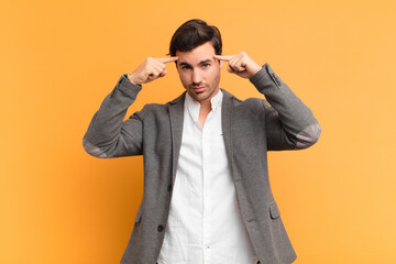 young handsome man with a serious and concentrated look, brainstorming and thinking about a challenging problem