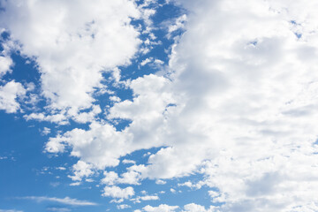 White fluffy clouds over blue sky