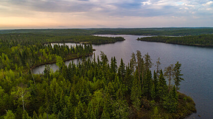 Fototapeta na wymiar Drone photo over the northern Boreal Forest at sunrise 