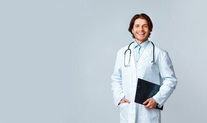 Medical Healthcare. Portrait of confident male doctor with stethoscope and clipboard - obrazy, fototapety, plakaty