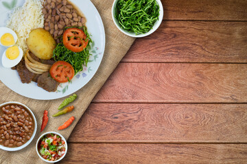 Brazilian food dish. Wood background. Top view.