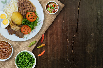 Fototapeta na wymiar Brazilian food dish. Wood background. Top view.