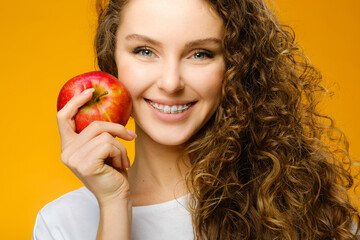 Pretty curly girl with red apple