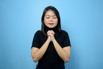 Portrait of Young beautiful asian women wearing black turtle neck shirt with blue isolated background