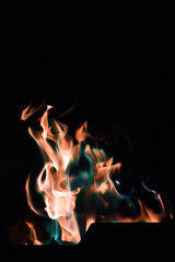 Colourful fire burning at campsite at night