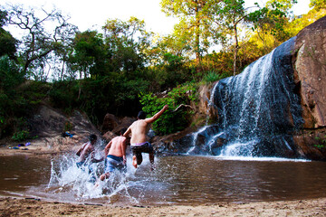 boys playing in a waterfall