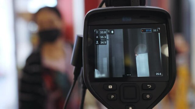 Temperature check at a supermarket, grocery store with thermal imaging camera installed. Image monitoring scanner to monitor the body temp of visitor customer. Coronavirus pandemic outbreak. Covid-19.