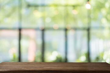 empty wooden table with soft focus background bokeh.