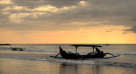 Beautiful Sunset at  Bali Beach featuring fisherman boat