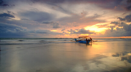 Beautiful Sunset at  Bali Beach featuring fisherman boat