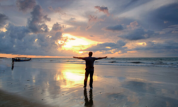 Silhouette of a man at Sunset Beach, Bali during sunset