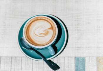 A stylish cup of coffee with latte art on a white background table
