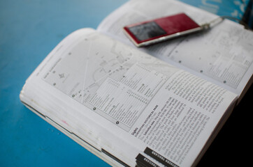Travel guide book on table with electronic device