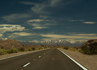 Travel. Open road into the Andes mountains. Asphalt highway across the desolated desert