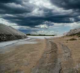 Industry. Salt mining. Salt flats under a stormy dramatic sky