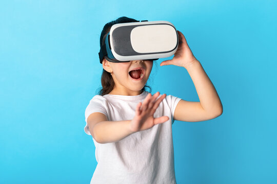 Little girl wearing virtual reality goggles at studio - Powered by Adobe